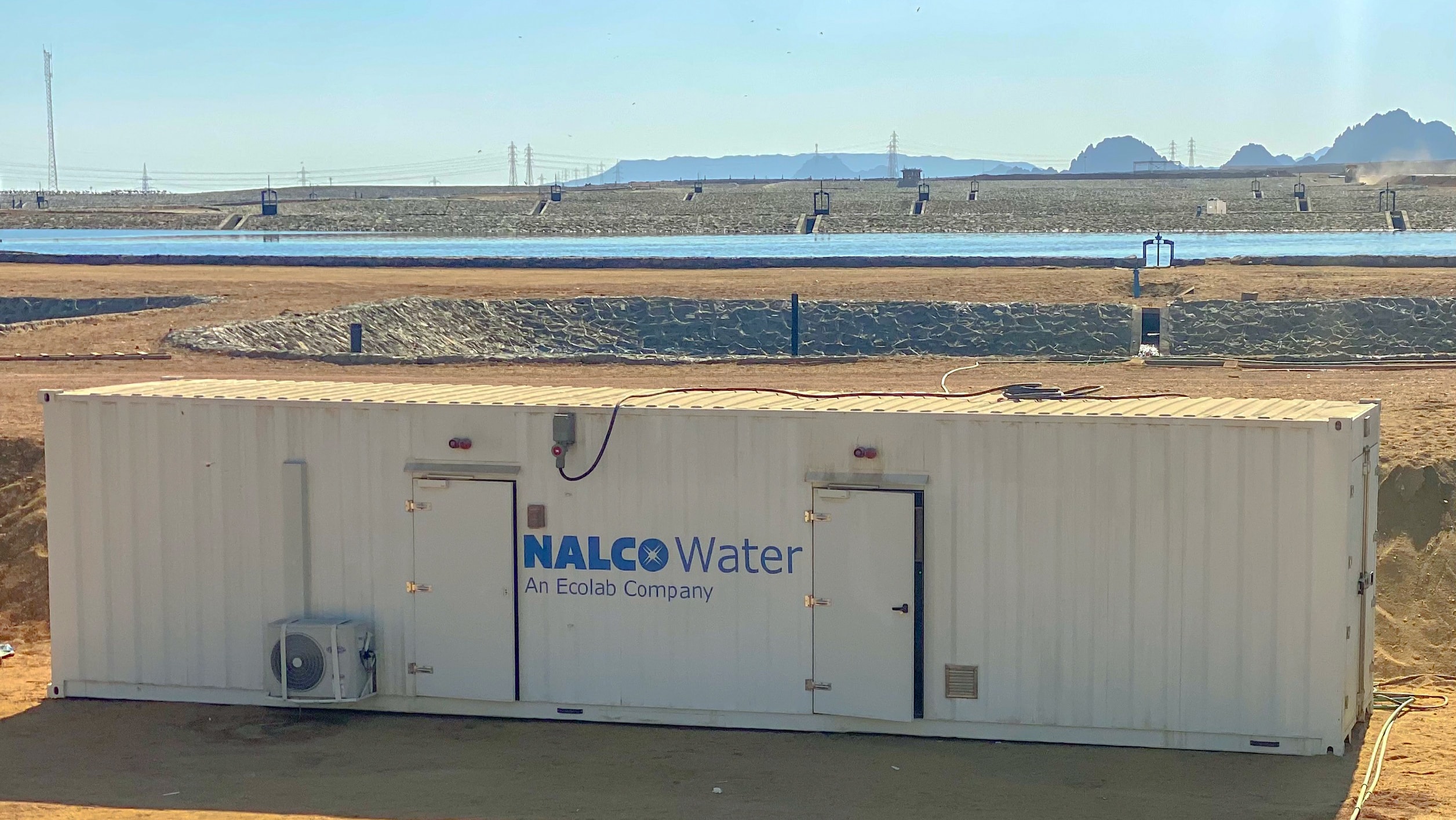 NalcoWater container in front of a body of water