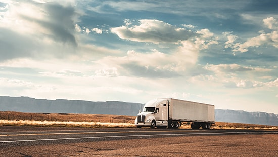 Semi-truck driving down rural highway