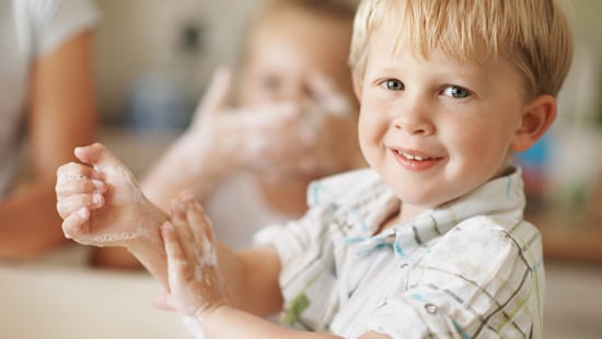 Boy washing hands.