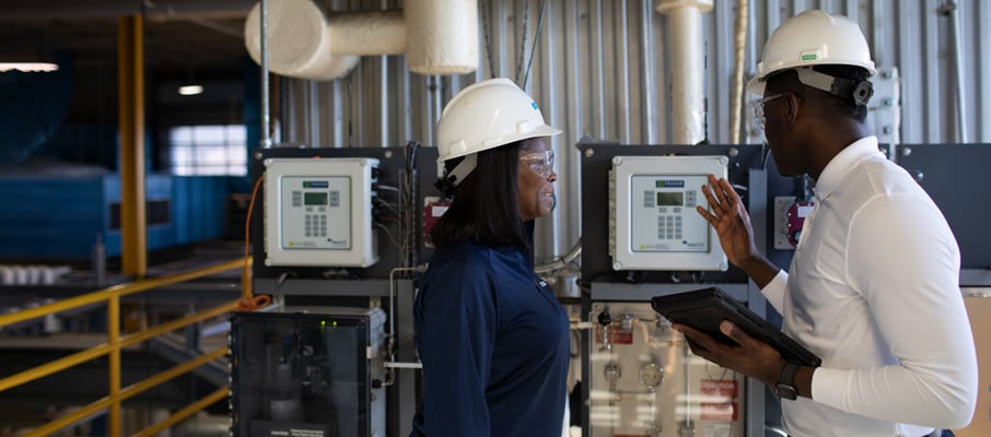 Two Ecolab associates in a facility using Ecolab 3D TRASAR Technology.