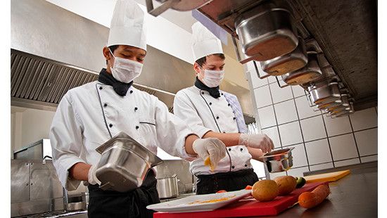 Ecolab Science Certified program image of kitchen chef with protective mask.